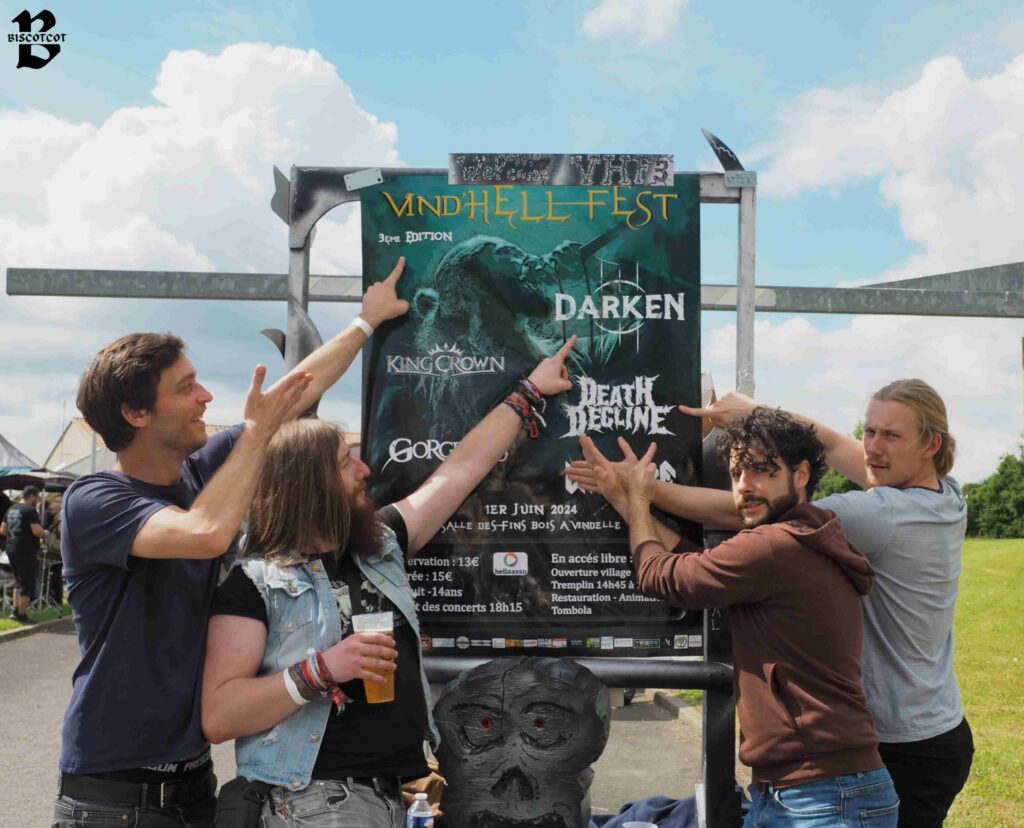 Le groupe de métal Wildfire devant l'affiche du Vind'Hell Fest III.